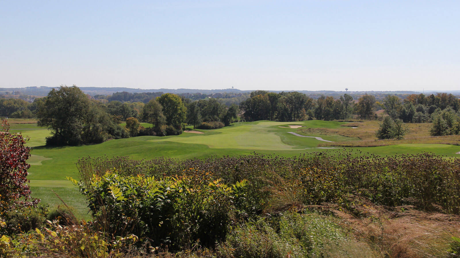 Green turf and lush foliage cover the University Ridge Golf Course