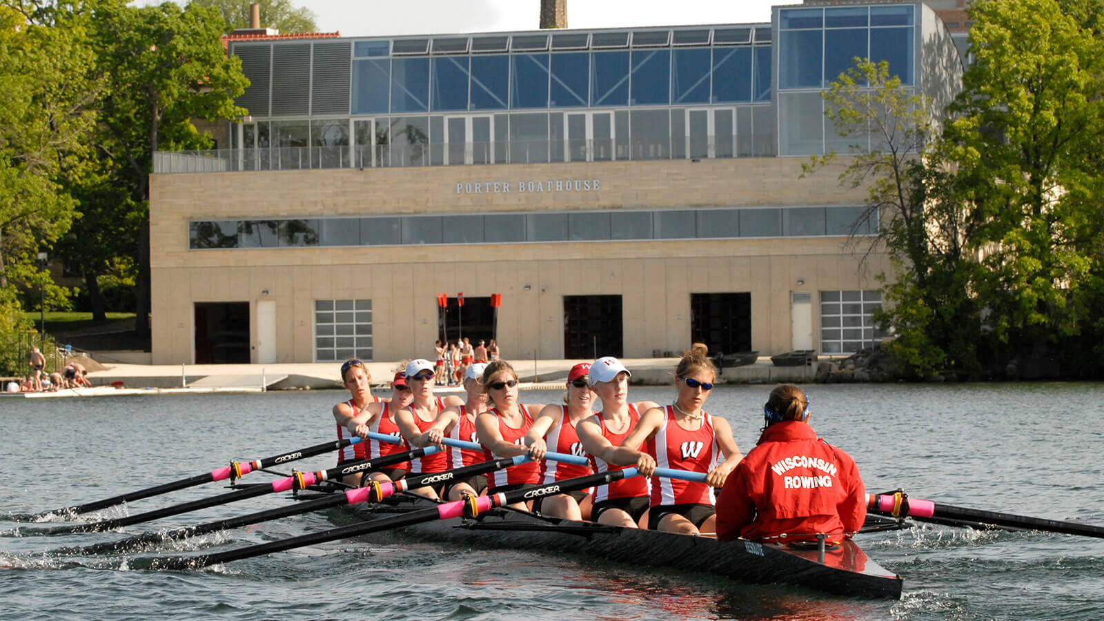 The Badger women's rowing team practices on Lake Mendota outside of the Porter Boathouse
